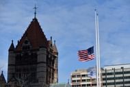 Flags fly at half staff near Trinity Church April 16, 2013 in Boston